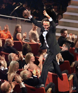 Director and actor Roberto Benigni jumps on the back of some chairs in excitement after winning the Oscar for best foreign language film for "Life is Beautiful," during the 71st Annual Academy Awards at the Dorothy Chandler Pavilion of the Los Angeles Music Center, Sunday, March 21, 1999. (AP Photo/Eric Draper)